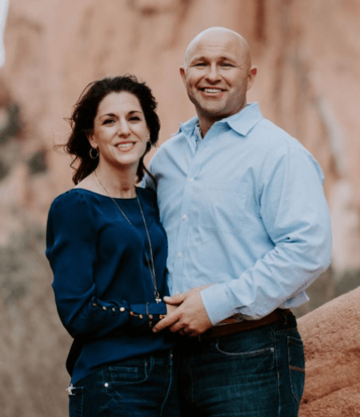 Veteran and spouse standing together outdoors