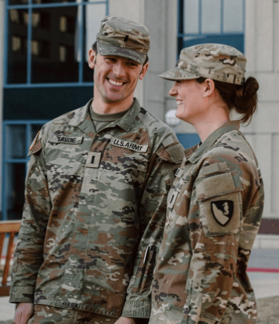 Two Army service members smiling together in uniform